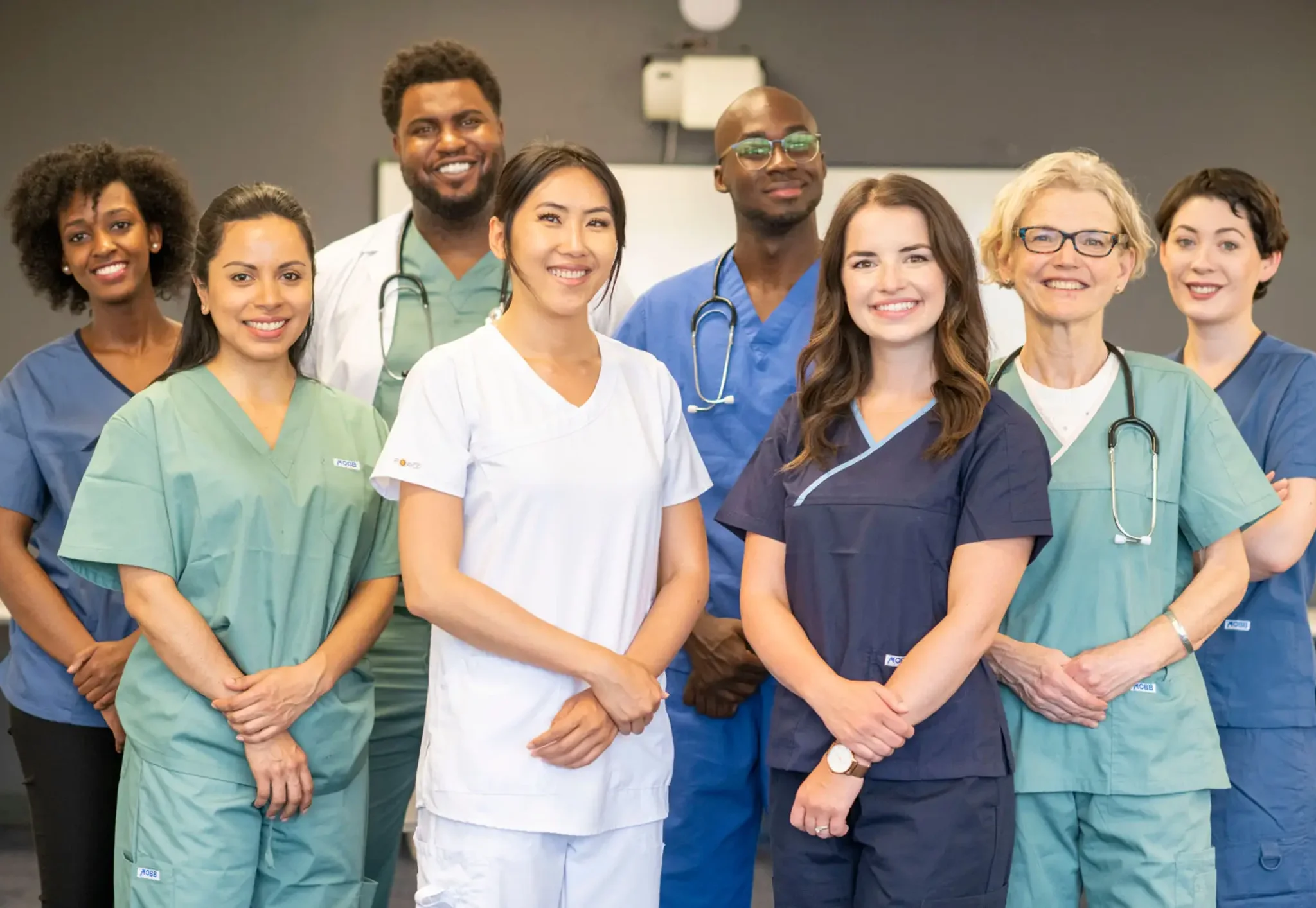 Smiling medical team in mixed-color scrubs