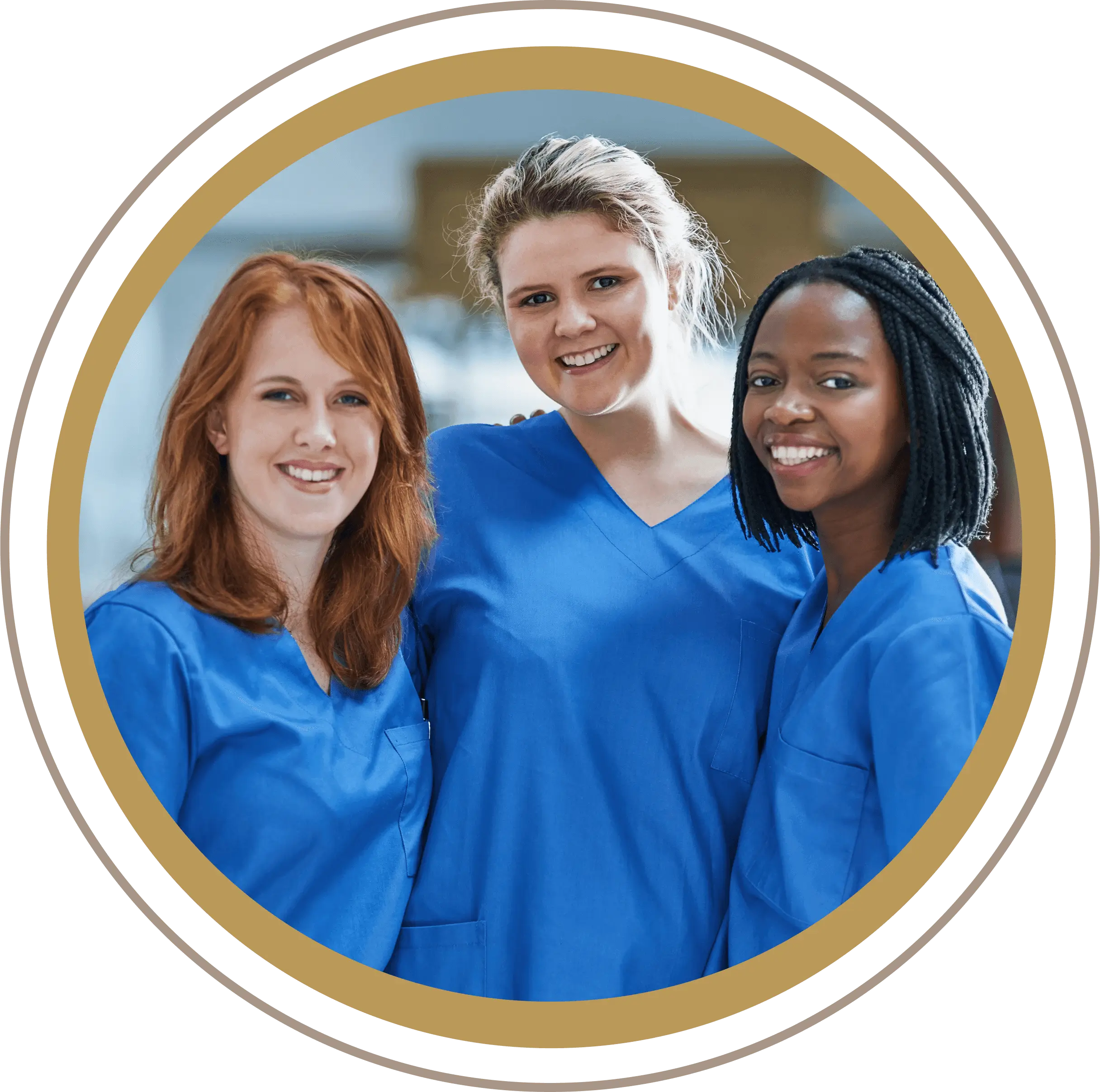 Three diverse female healthcare professionals smiling in blue scrubs.
